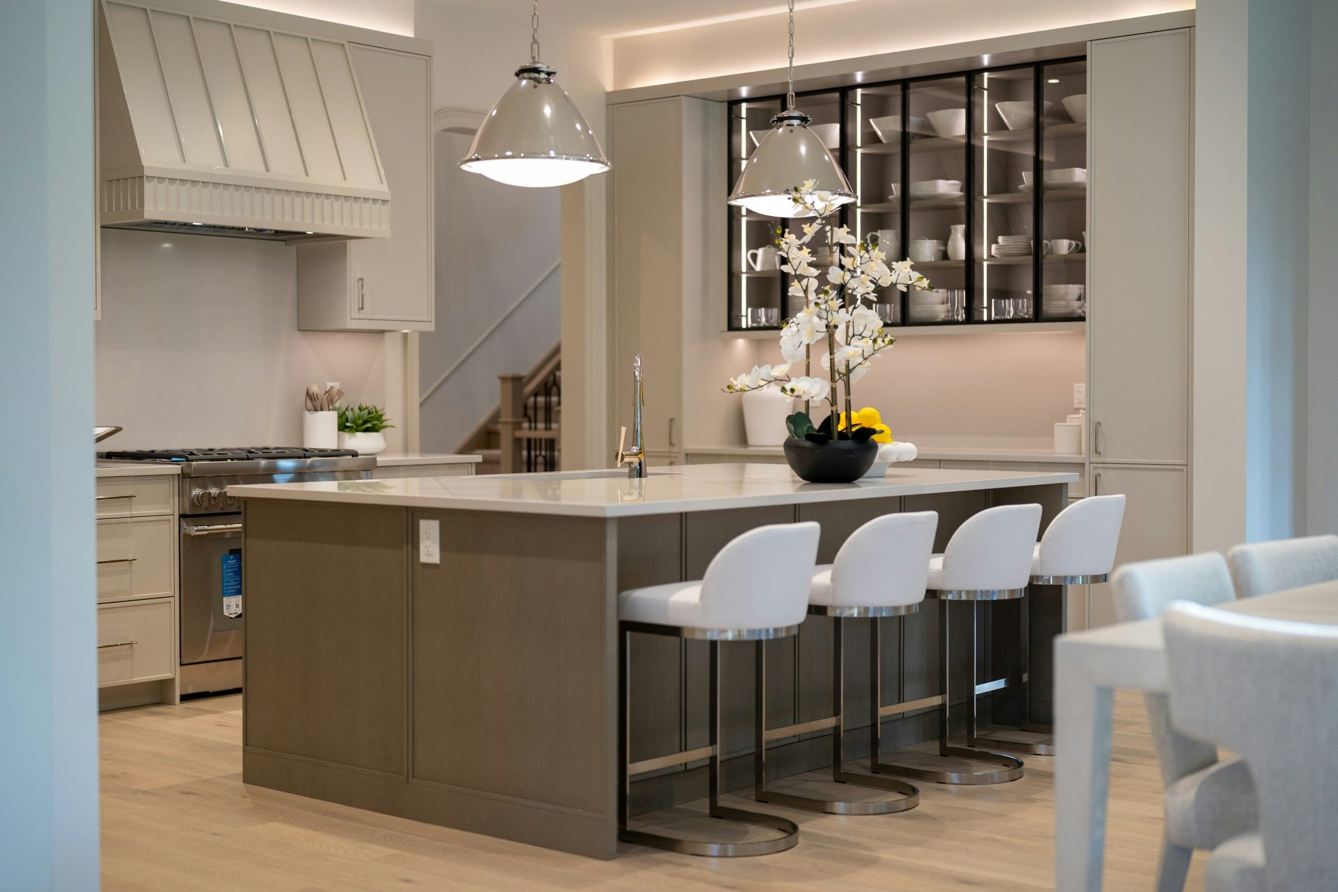 Modern kitchen island with white bar stools