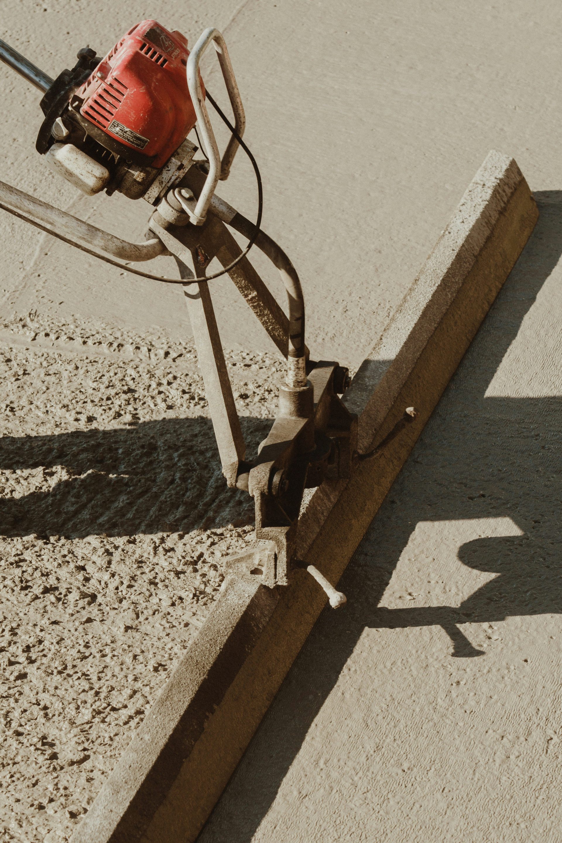 a red and black machine on a sidewalk
